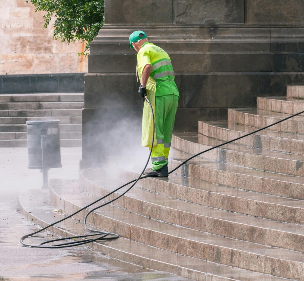 Man Cleaning Stairs on Street